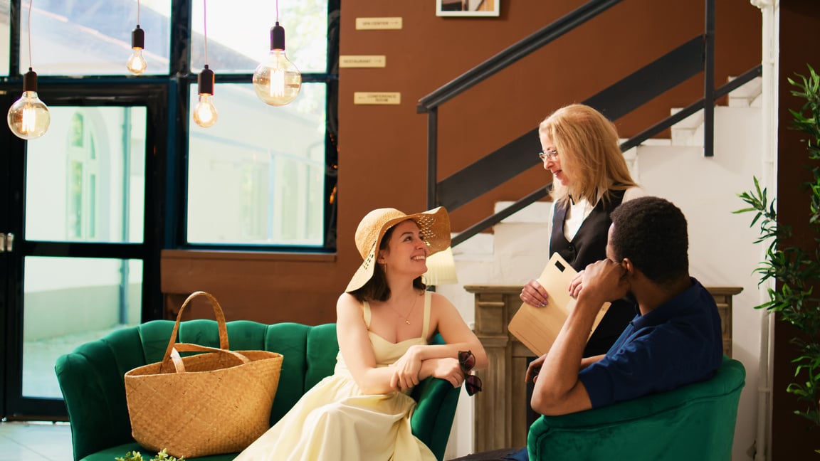 Receptionist talking to hotel guests